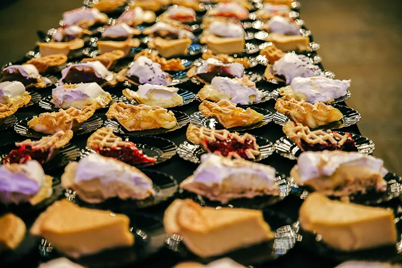 A table full of plates of slices of pie from the Blue Gate Restuarant